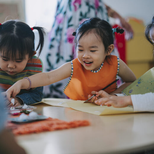 A group of young children playing at a table.